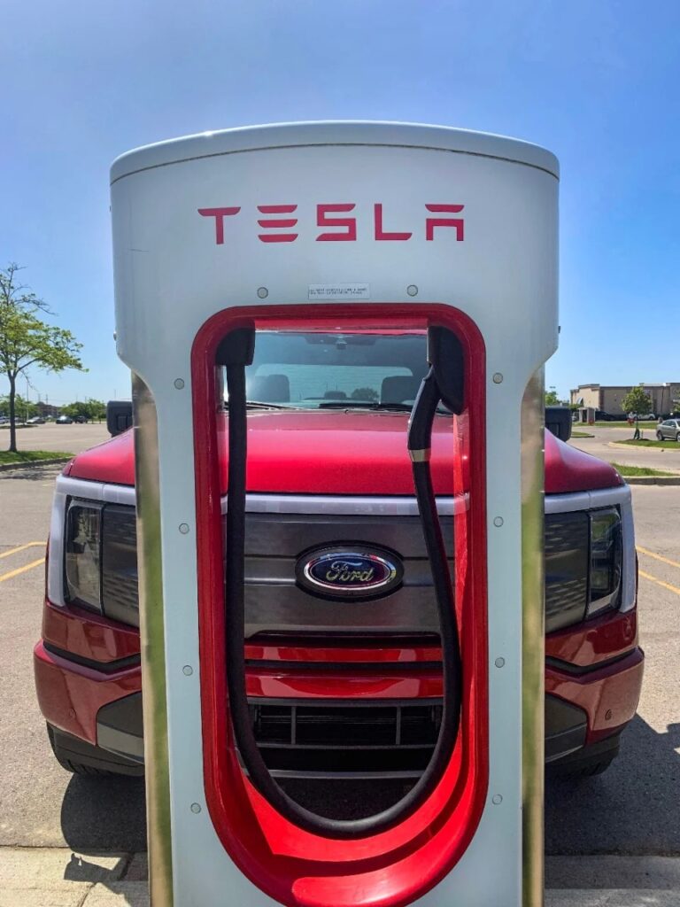 2025 Ford F-150-Lightning Flash in front of Tesla charging station