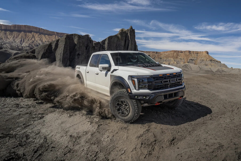 2025 Ford F-150 Raptor driving through desert terrain