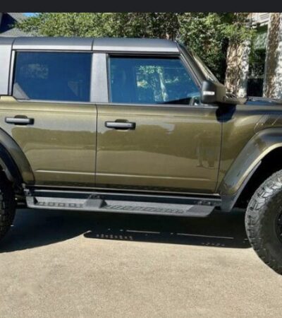Raptor Bronco off-roading in rugged outdoor terrain.