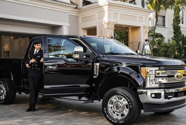 Ford Super Duty with concierge in upscale driveway