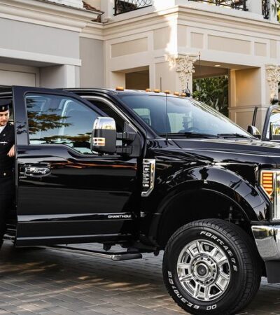 Ford Super Duty with concierge in upscale driveway
