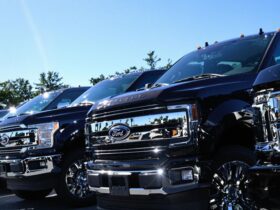 Lineup of new Ford pickup trucks at dealership lot