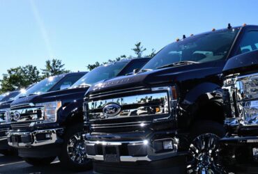 Lineup of new Ford pickup trucks at dealership lot