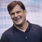 Jim Farley in a polo shirt on stage.