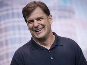 Jim Farley in a polo shirt on stage.