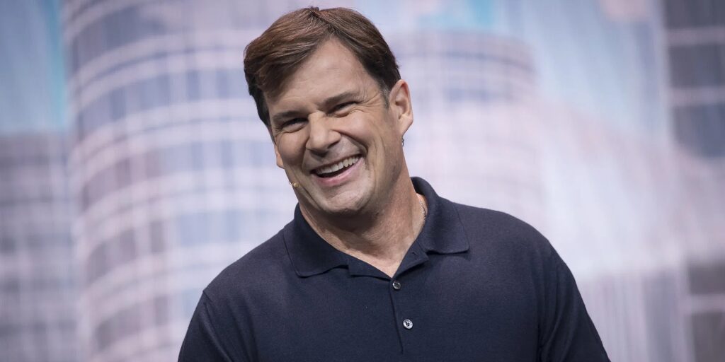 Jim Farley in a polo shirt on stage.